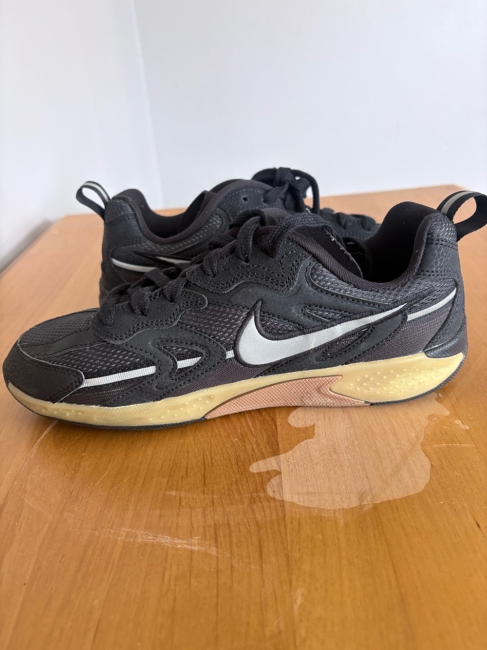 Nike Kids Black Sneakers with White Swoosh and Yellowed Sole
